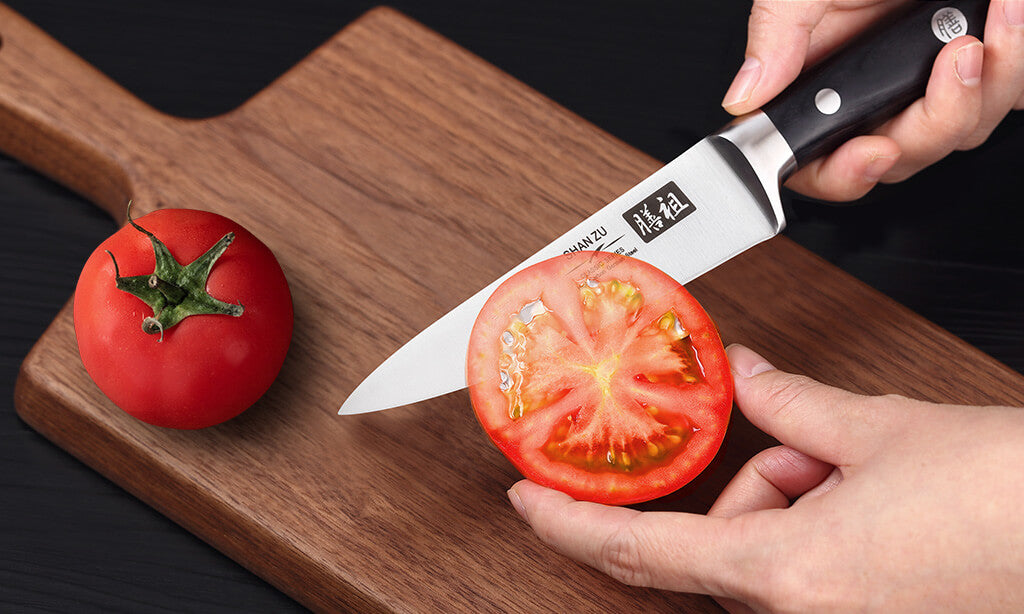 https://www.shanzuchef.com/cdn/shop/articles/cut_a_tomato_with_shan_zu_classic_fruit_knife.jpg?v=1640246867